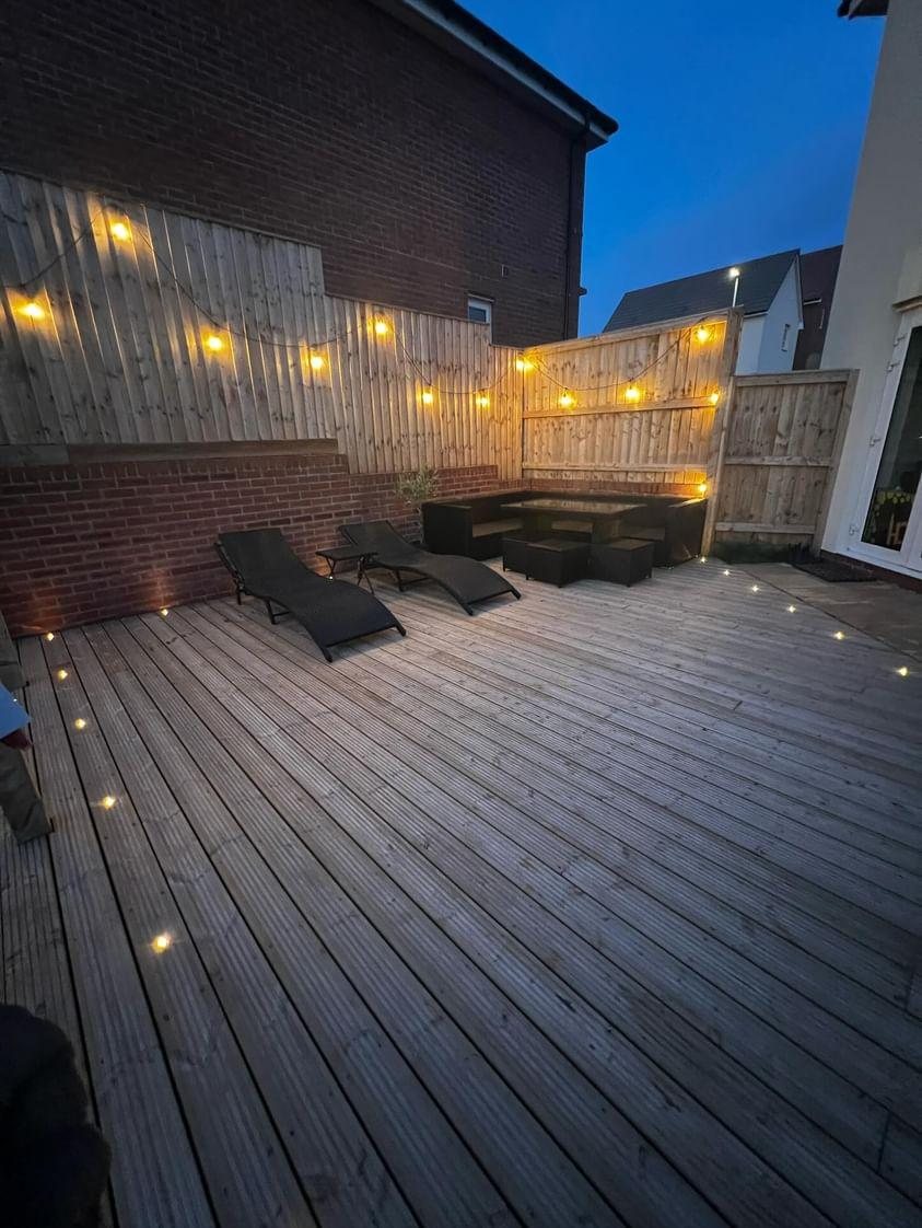 Warm decorative lighting across a timber deck