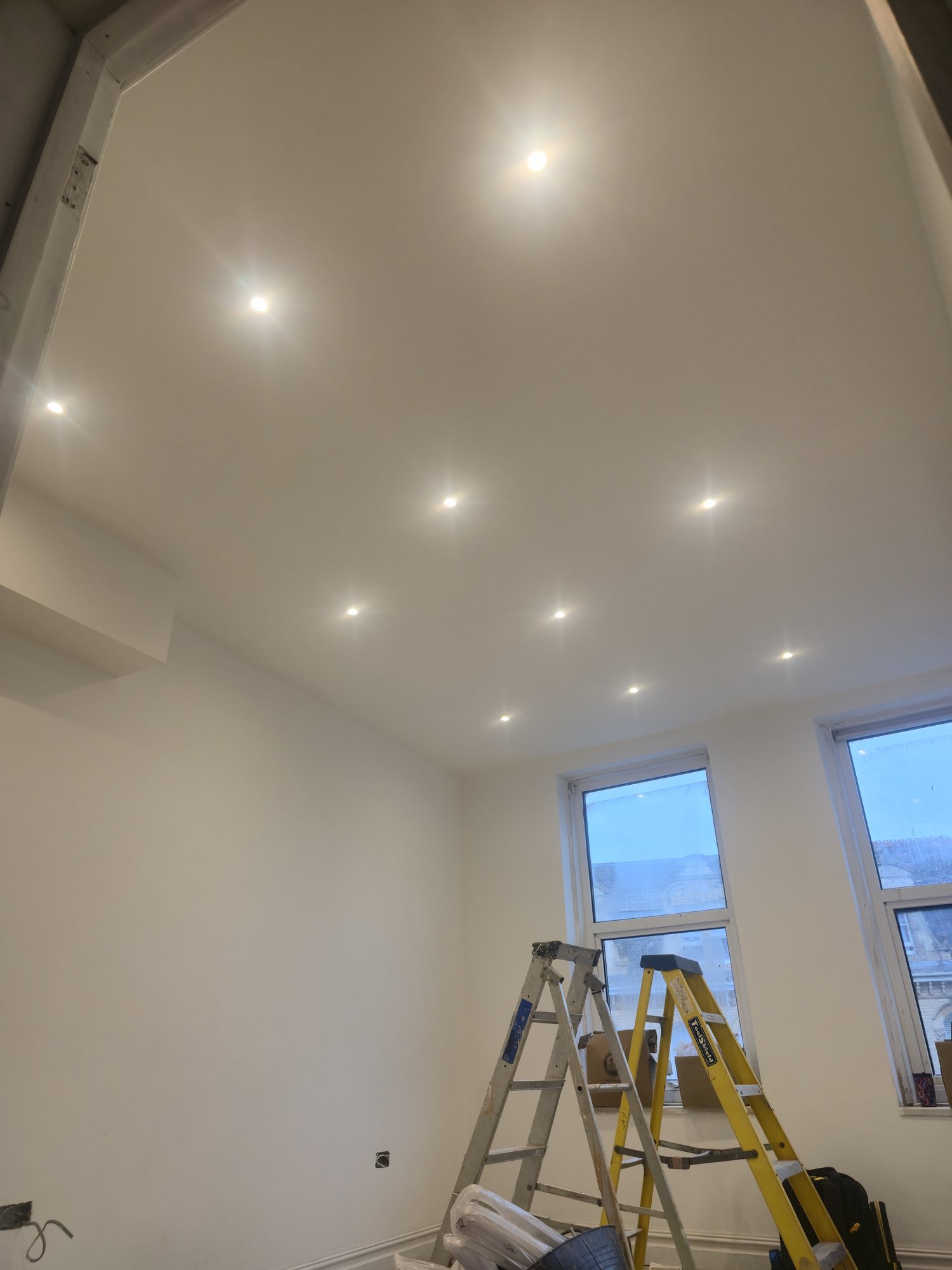 Finished recessed ceiling lights in a renovated room
